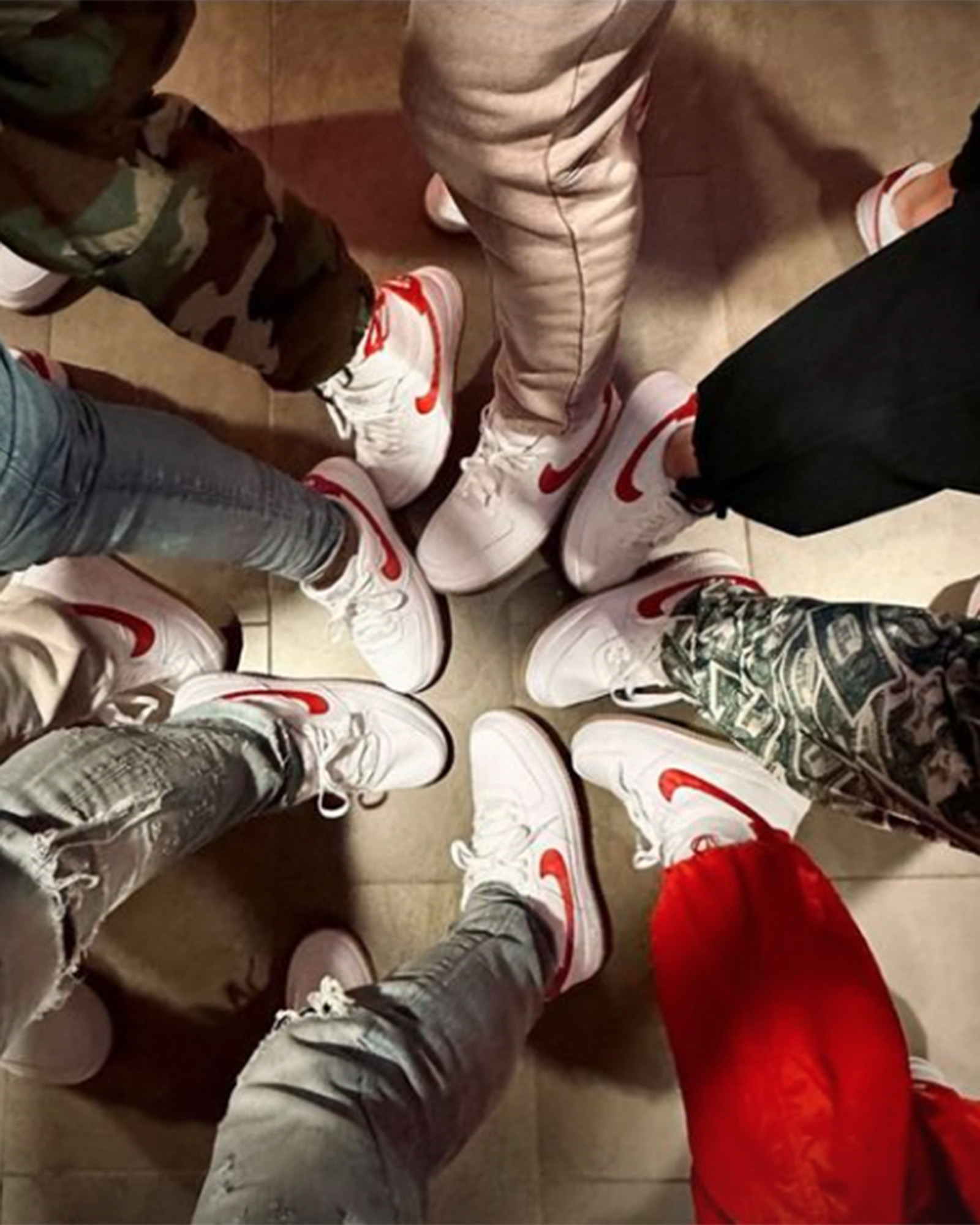A group of people wearing red-and-white Nikes